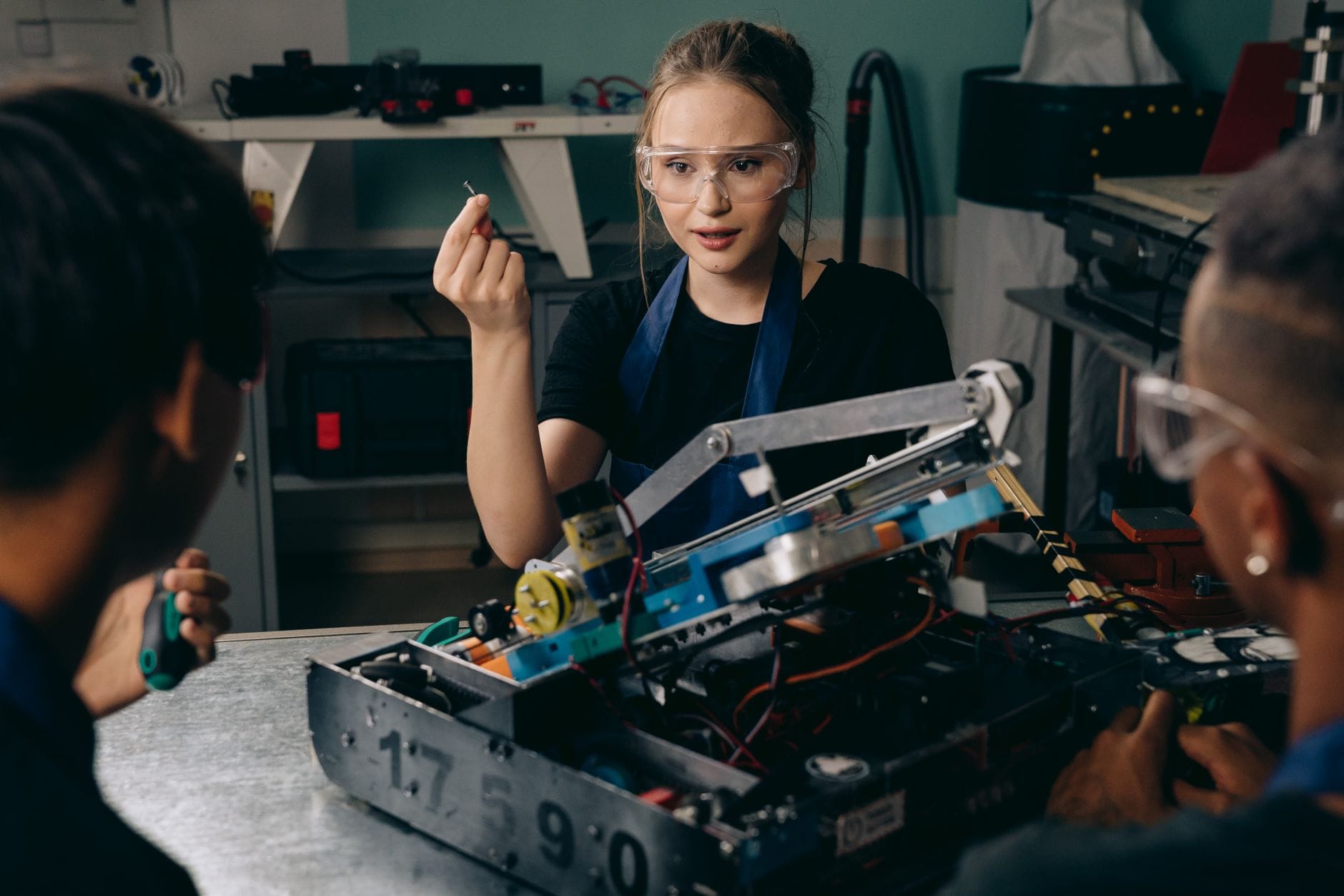 Młodzi inżynierowie pracujący wspólnie nad projektem robotyki w warsztacie